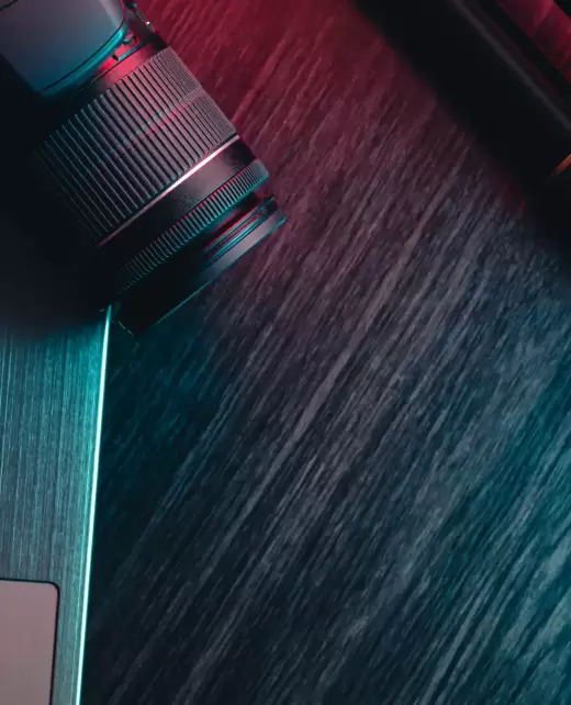 a-workspace-with-laptop-lens-and-tripod-on-a-wood-2023-11-27-04-53-35-utc